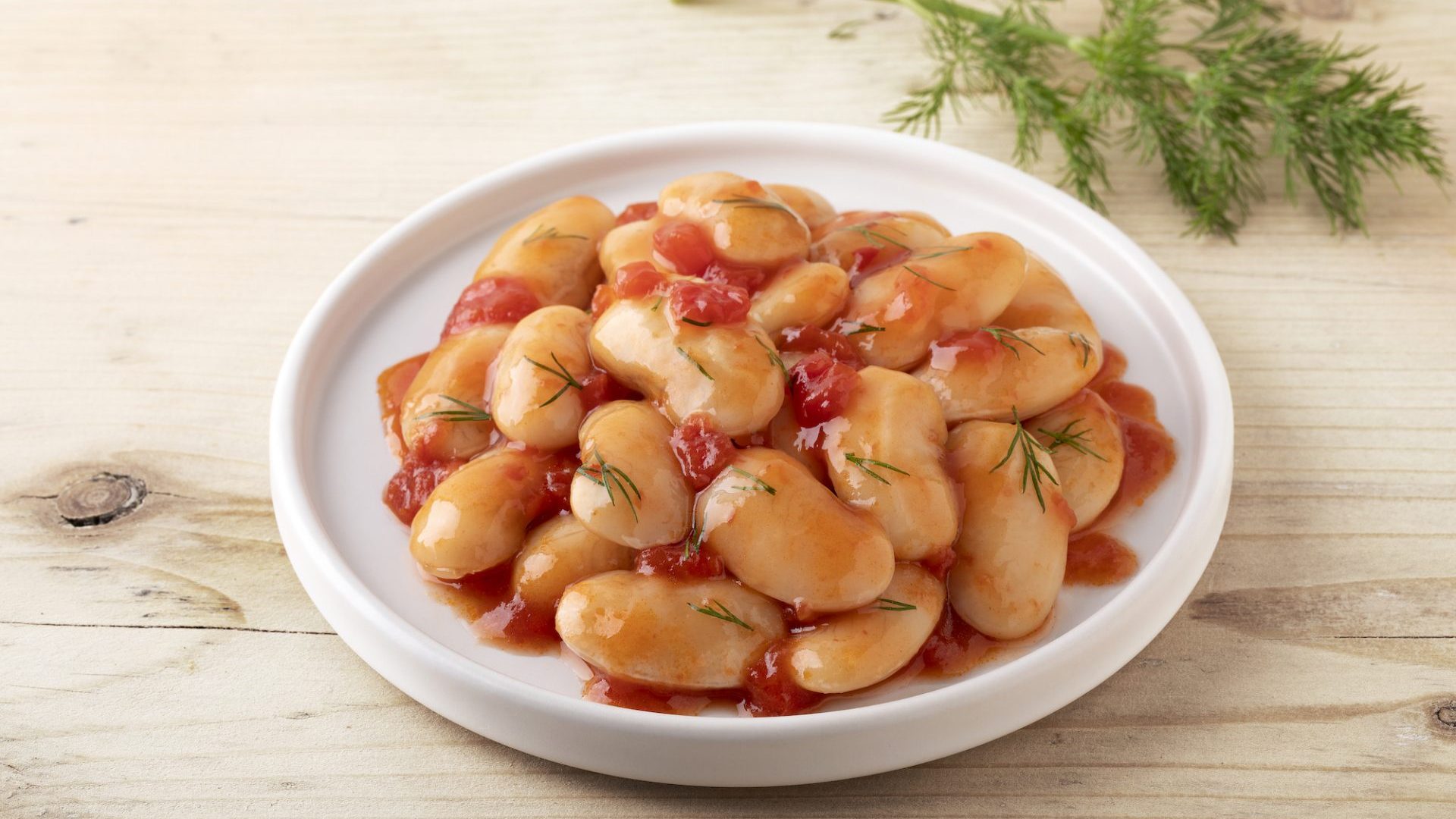 Giant beans in onion & tomato sauce in a plate